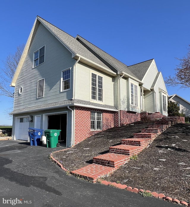 878 Buttermilk Ct, Harrisburg, PA 17111 - view of property exterior with a shingled roof, a garage, and aphalt driveway