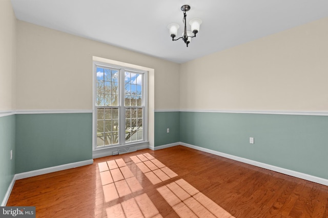 878 Buttermilk Ct, Harrisburg, PA 17111 - empty room with a chandelier, wood finished floors, baseboards, and visible vents