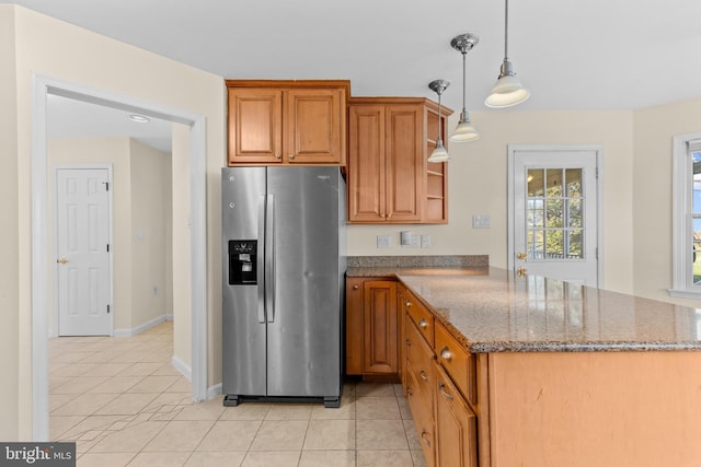 878 Buttermilk Ct, Harrisburg, PA 17111 - kitchen with light tile patterned floors, stainless steel refrigerator with ice dispenser, a peninsula, brown cabinetry, and dark stone counters