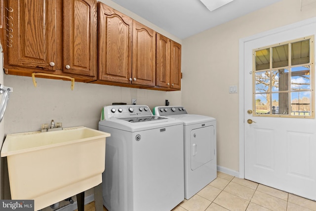 878 Buttermilk Ct, Harrisburg, PA 17111 - laundry room featuring light tile patterned floors, a sink, baseboards, cabinet space, and washer and clothes dryer