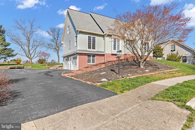 878 Buttermilk Ct, Harrisburg, PA 17111 - view of front of house with a shingled roof, a garage, driveway, and brick siding