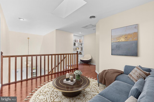 878 Buttermilk Ct, Harrisburg, PA 17111 - living area with baseboards, an upstairs landing, visible vents, a skylight, and wood finished floors