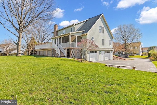 878 Buttermilk Ct, Harrisburg, PA 17111 - view of side of home with a sunroom, an attached garage, a chimney, stairway, and driveway
