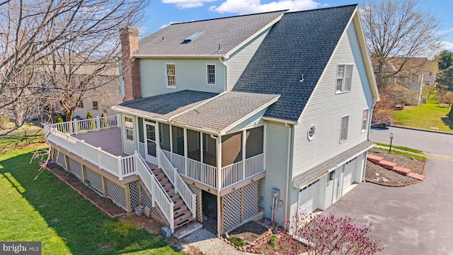 878 Buttermilk Ct, Harrisburg, PA 17111 - back of house featuring roof with shingles, a chimney, stairs, a yard, and a sunroom