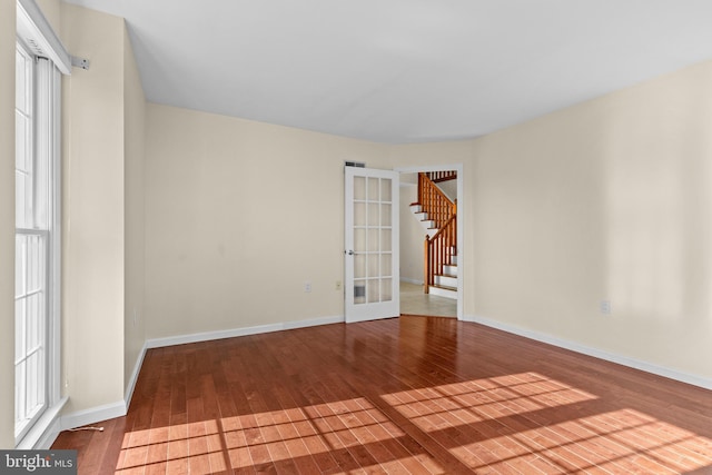 878 Buttermilk Ct, Harrisburg, PA 17111 - spare room with french doors, baseboards, stairway, and hardwood / wood-style flooring