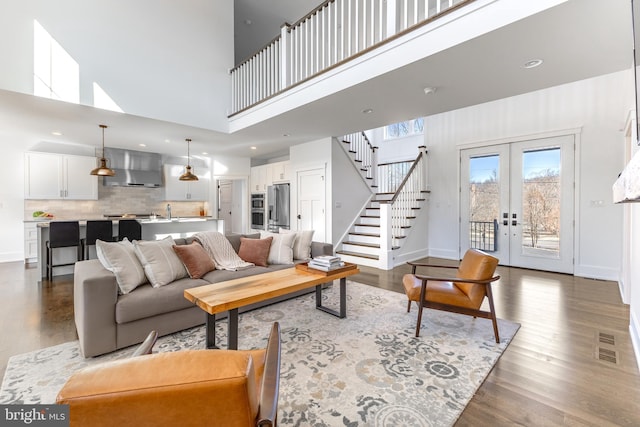 330 Trout Rd, State College, PA 16801 - living room with french doors, stairway, baseboards, and dark wood-type flooring