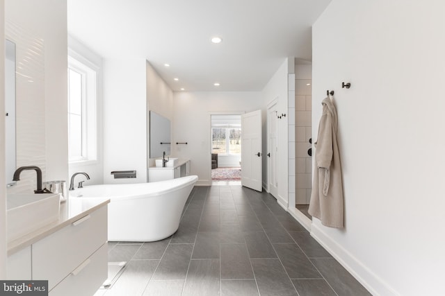 330 Trout Rd, State College, PA 16801 - bathroom with two vanities, a soaking tub, tile patterned flooring, baseboards, and recessed lighting