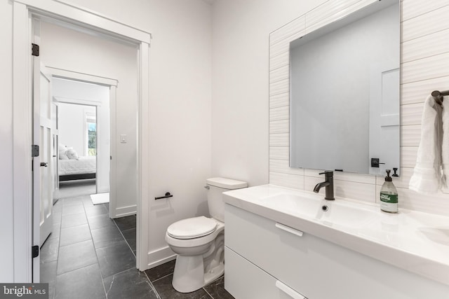330 Trout Rd, State College, PA 16801 - bathroom featuring toilet, vanity, baseboards, and ensuite bath
