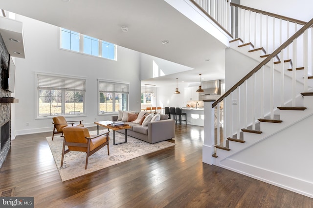 330 Trout Rd, State College, PA 16801 - living room with a stone fireplace, plenty of natural light, and wood finished floors