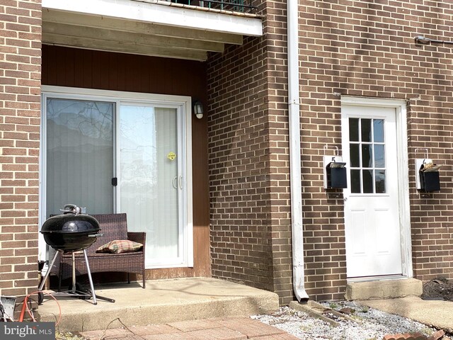 1294 Cooper St Unit B5, Edgewater Park, NJ 08010 - view of exterior entry featuring a balcony and brick siding