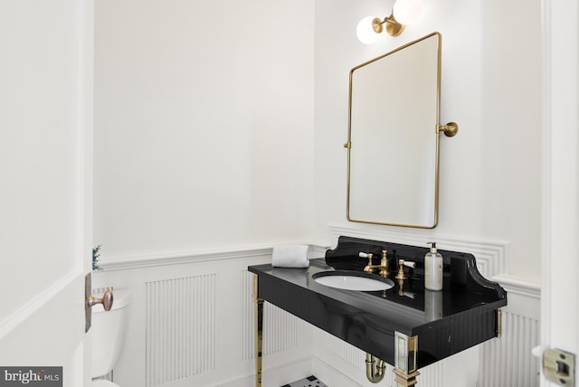 827 Turkey Run Rd, Mclean, VA 22101 - half bath with wainscoting, a decorative wall, and vanity
