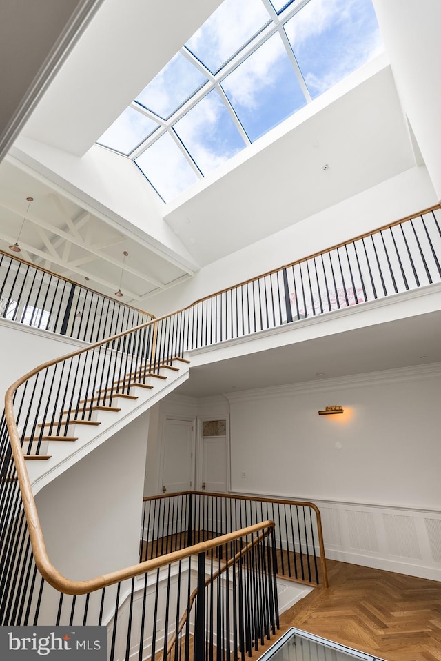 827 Turkey Run Rd, Mclean, VA 22101 - stairway with a skylight, a towering ceiling, a wainscoted wall, and plenty of natural light