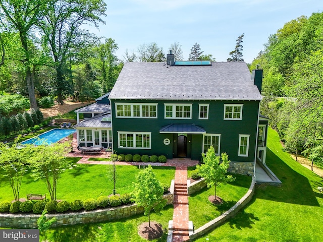 827 Turkey Run Rd, Mclean, VA 22101 - view of front of property with a chimney, a patio, a front yard, and roof mounted solar panels