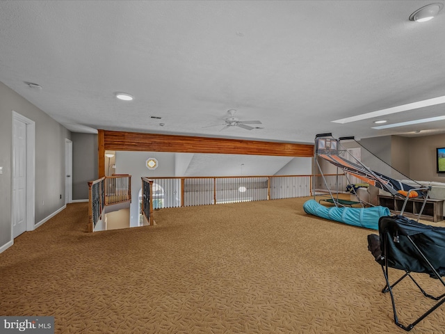 playroom featuring carpet flooring, a ceiling fan, and baseboards