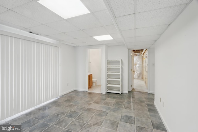 8219 Selwin Ct, Baltimore, MD 21237 - basement featuring a paneled ceiling and baseboards