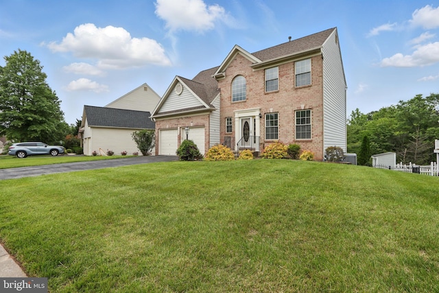 8219 Selwin Ct, Baltimore, MD 21237 - view of front of house with brick siding, asphalt driveway, an attached garage, and a front yard