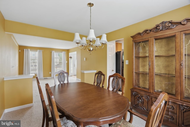 8219 Selwin Ct, Baltimore, MD 21237 - dining room featuring a chandelier, light carpet, and baseboards