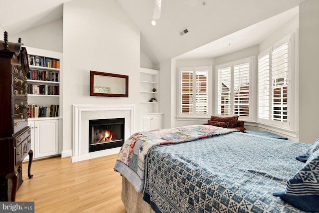 808 Cameron St, Alexandria, VA 22314 - bedroom featuring light wood-style floors, a glass covered fireplace, and high vaulted ceiling