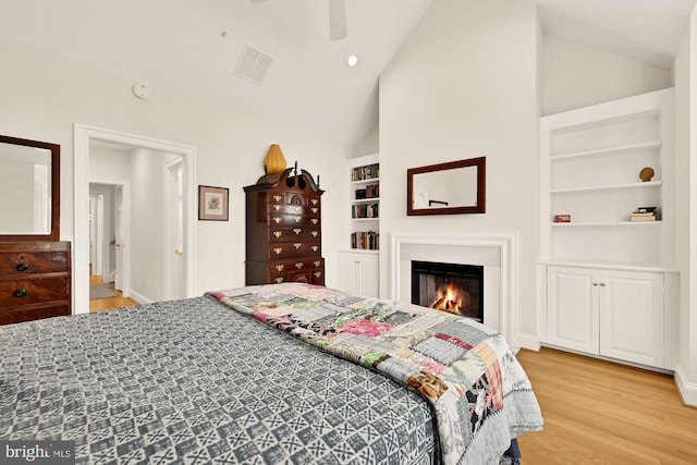 808 Cameron St, Alexandria, VA 22314 - bedroom with lofted ceiling, light wood-style floors, a lit fireplace, baseboards, and a ceiling fan