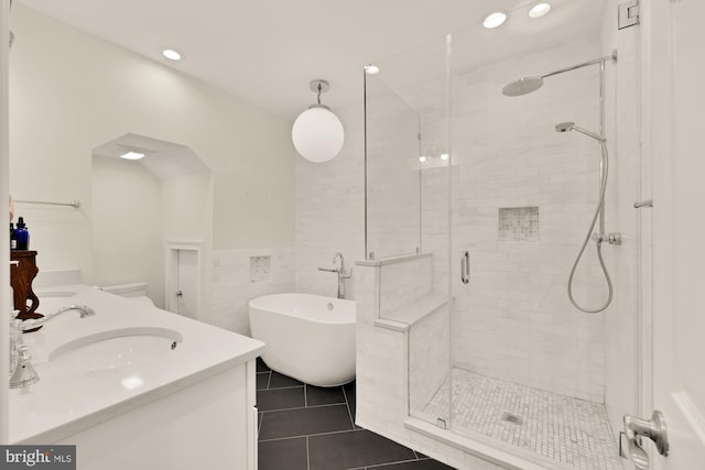 808 Cameron St, Alexandria, VA 22314 - bathroom with a freestanding bath, a stall shower, double vanity, tile walls, and recessed lighting