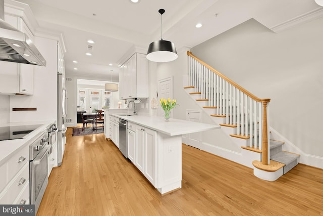 808 Cameron St, Alexandria, VA 22314 - kitchen featuring wall chimney range hood, stainless steel appliances, light wood-type flooring, recessed lighting, and white cabinets