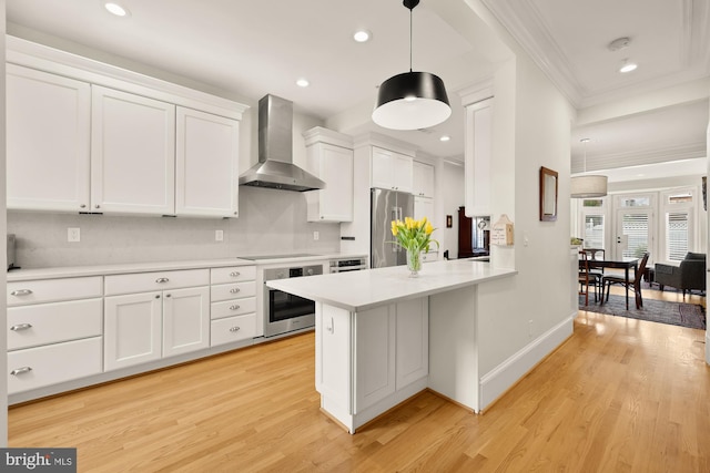 808 Cameron St, Alexandria, VA 22314 - kitchen featuring wall chimney exhaust hood, stainless steel appliances, crown molding, light countertops, and white cabinets