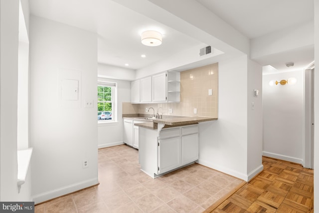 2107 N Taft St Unit 11, Arlington, VA 22201 - kitchen with open shelves, white cabinetry, a sink, baseboards, and dishwasher