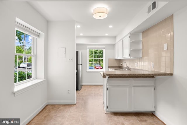 2107 N Taft St Unit 11, Arlington, VA 22201 - kitchen featuring freestanding refrigerator, open shelves, white cabinets, a sink, and baseboards