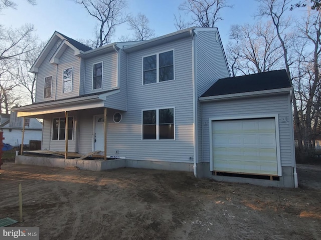 traditional home with an attached garage and a porch