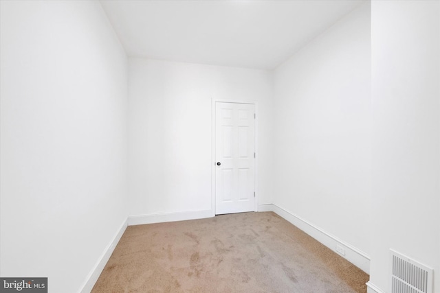 spare room with baseboards, carpet floors, and visible vents