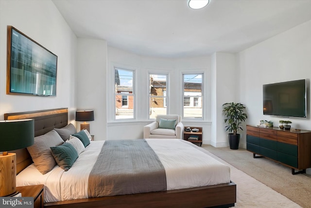 carpeted bedroom featuring baseboards