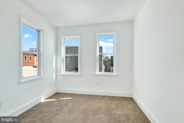 unfurnished room featuring baseboards and carpet floors