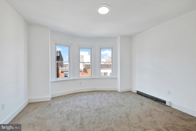 carpeted empty room with baseboards and a baseboard radiator
