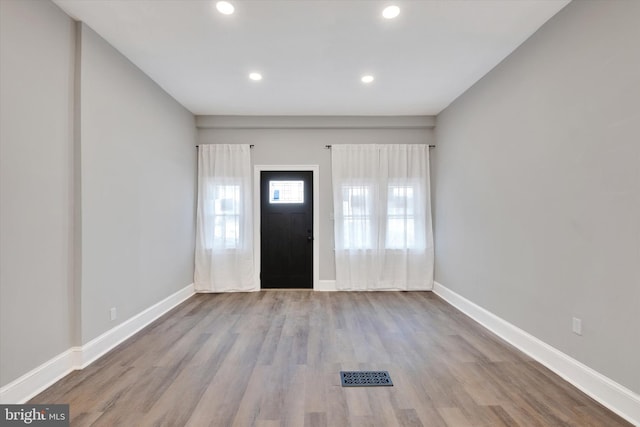 foyer with wood finished floors, recessed lighting, baseboards, and visible vents