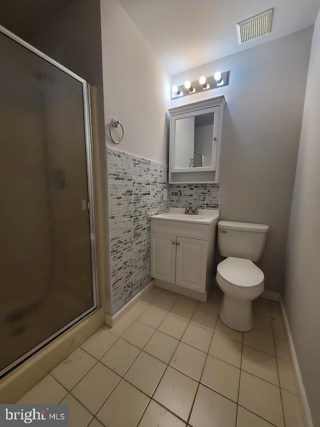 full bathroom featuring vanity, tile patterned floors, a shower stall, and visible vents