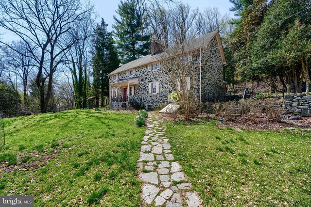 exterior space featuring a yard and a chimney