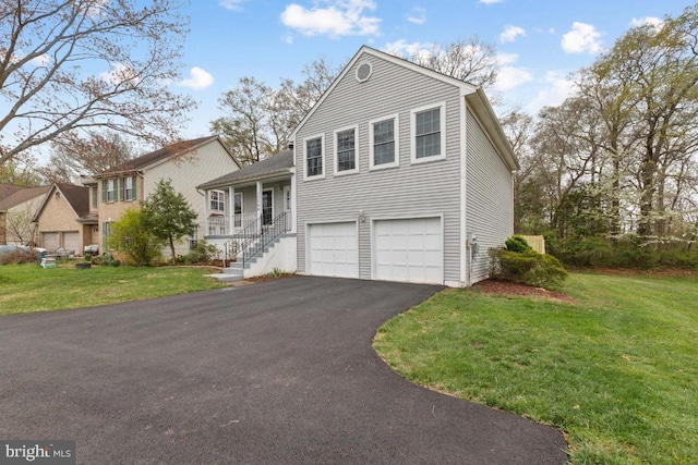 split level home featuring a front yard, driveway, and an attached garage