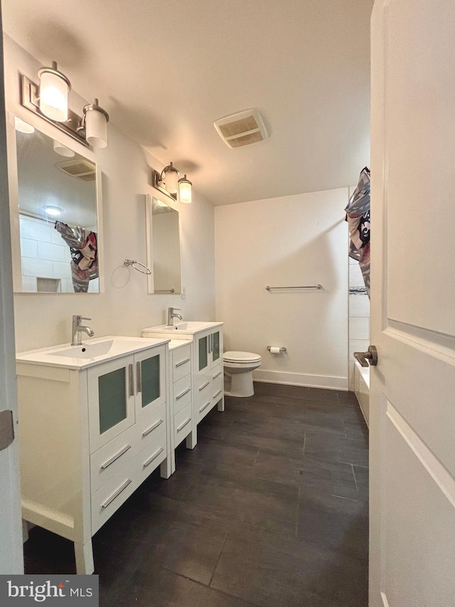1219 N 5th St Unit 2, Philadelphia, PA 19122 - full bathroom featuring double vanity, toilet, and wood finished floors