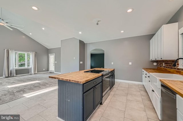 302 Haskell Dr, Arnold, MD 21012 - kitchen featuring butcher block counters, appliances with stainless steel finishes, a sink, arched walkways, and white cabinets