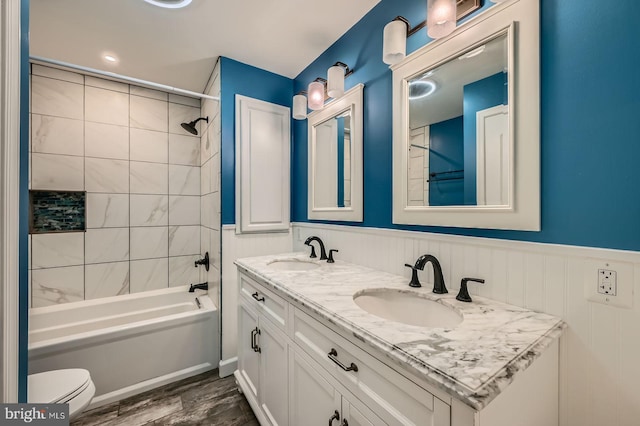 302 Haskell Dr, Arnold, MD 21012 - bathroom with wood finished floors, wainscoting, toilet, bathtub / shower combination, and double vanity