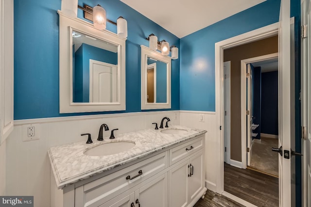 302 Haskell Dr, Arnold, MD 21012 - bathroom featuring wainscoting, wood finished floors, and double vanity