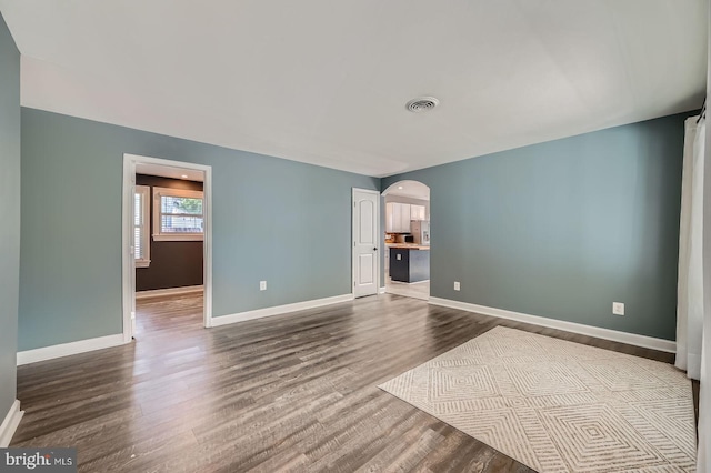 302 Haskell Dr, Arnold, MD 21012 - empty room with arched walkways, dark wood finished floors, and baseboards