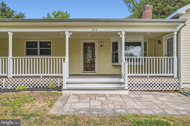 302 Haskell Dr, Arnold, MD 21012 - doorway to property featuring covered porch and a chimney
