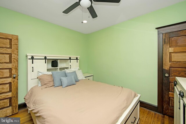bedroom featuring ceiling fan, wood finished floors, and recessed lighting