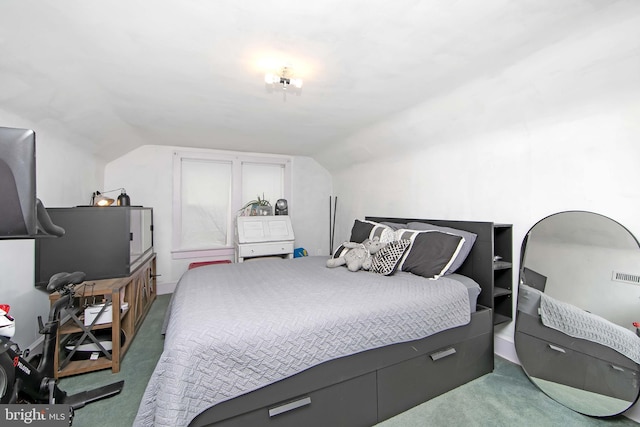 carpeted bedroom featuring lofted ceiling