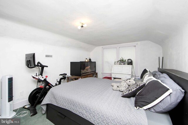 bedroom featuring vaulted ceiling, baseboards, and carpet floors