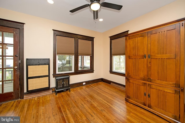 unfurnished bedroom with recessed lighting, wood finished floors, and baseboards