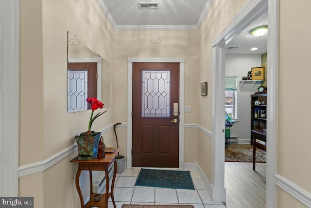 13113 Little Hayden Cir Unit 87, Hagerstown, MD 21742 - entryway featuring a textured ceiling, baseboards, ornamental molding, and visible vents