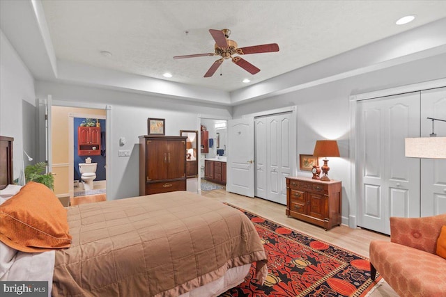 13113 Little Hayden Cir Unit 87, Hagerstown, MD 21742 - bedroom with ensuite bathroom, two closets, light wood-type flooring, a tray ceiling, and recessed lighting
