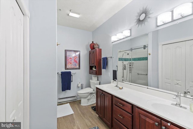 13113 Little Hayden Cir Unit 87, Hagerstown, MD 21742 - bathroom with a sink, toilet, wood finished floors, and baseboard heating